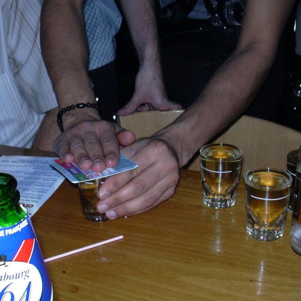 A table in a pub with lots of drink on it.