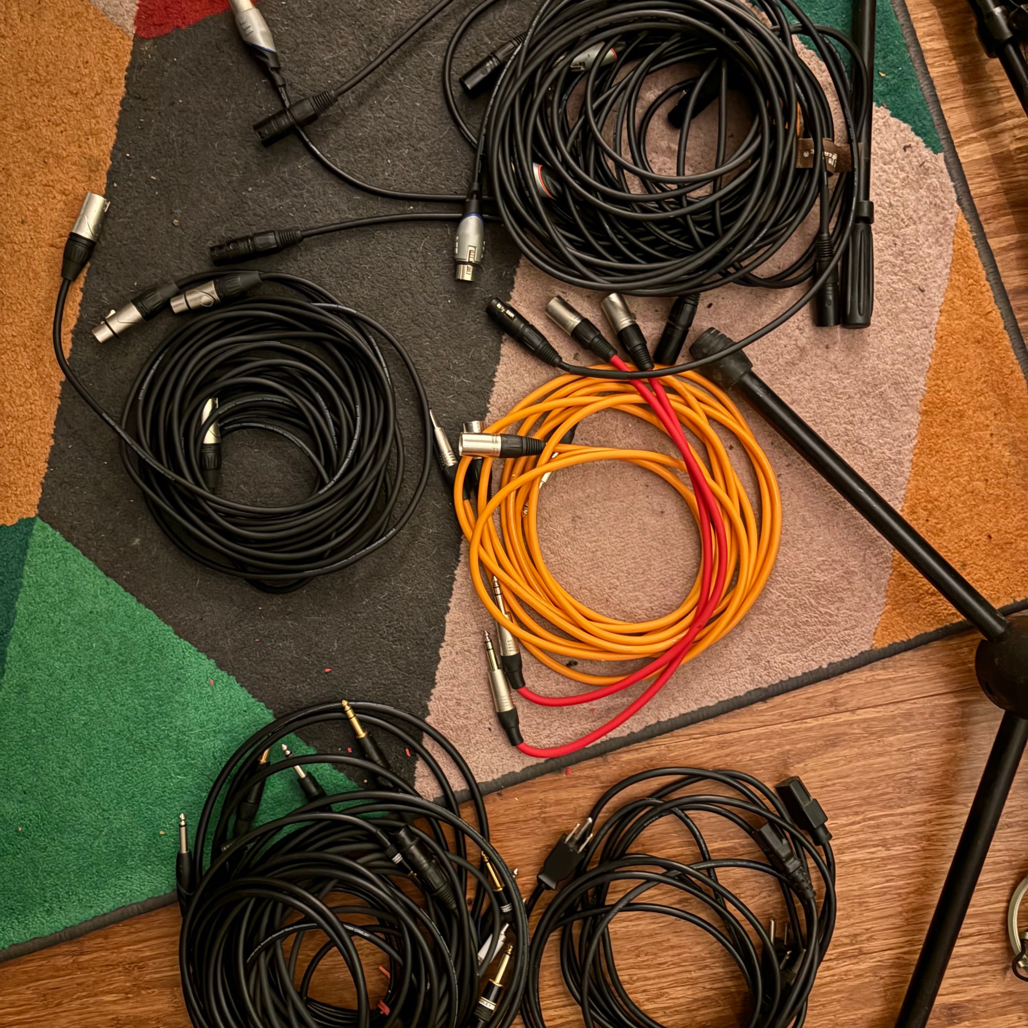A variety of cables lying on a rug on the floor