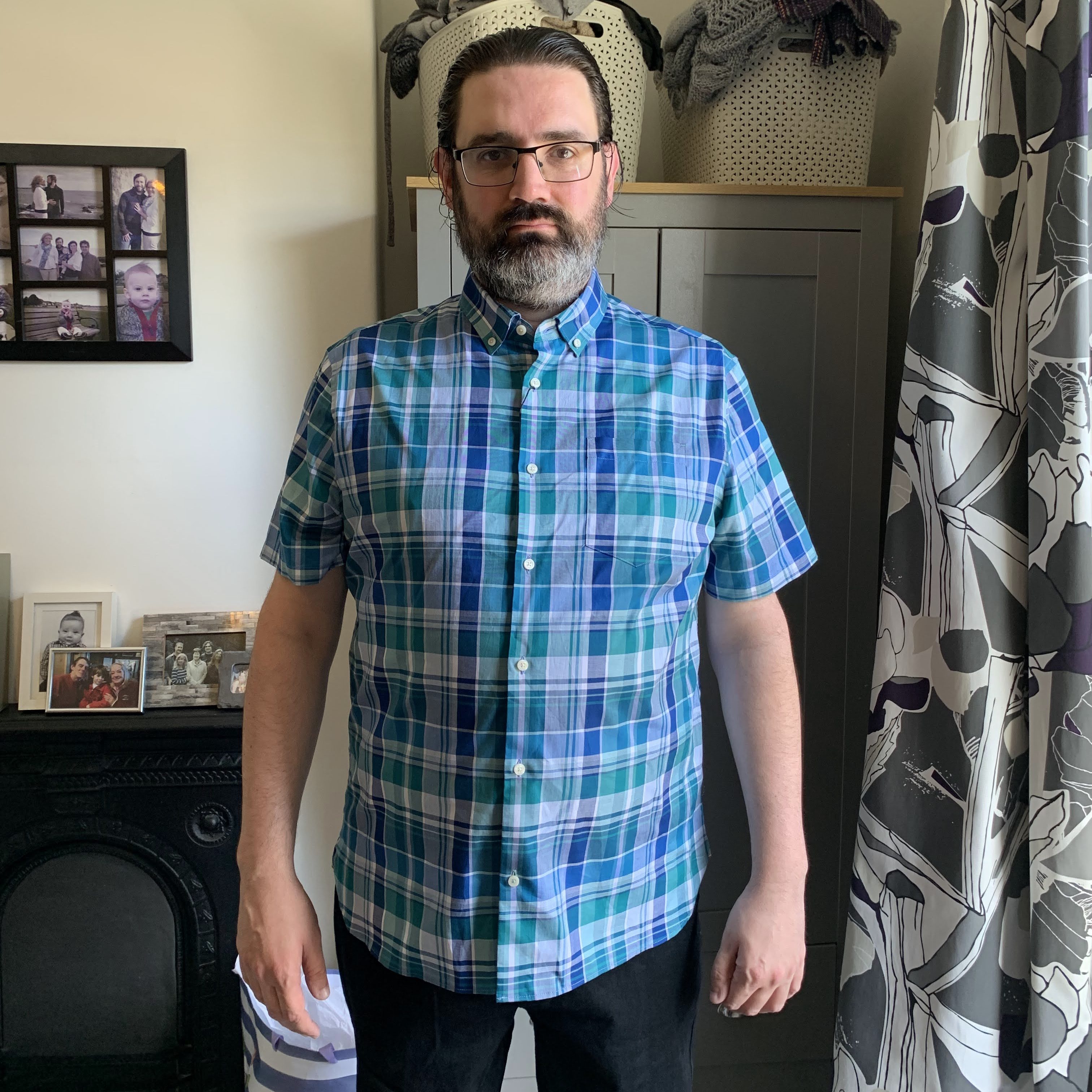 A picture of me, looking at the camera, standing in my house.