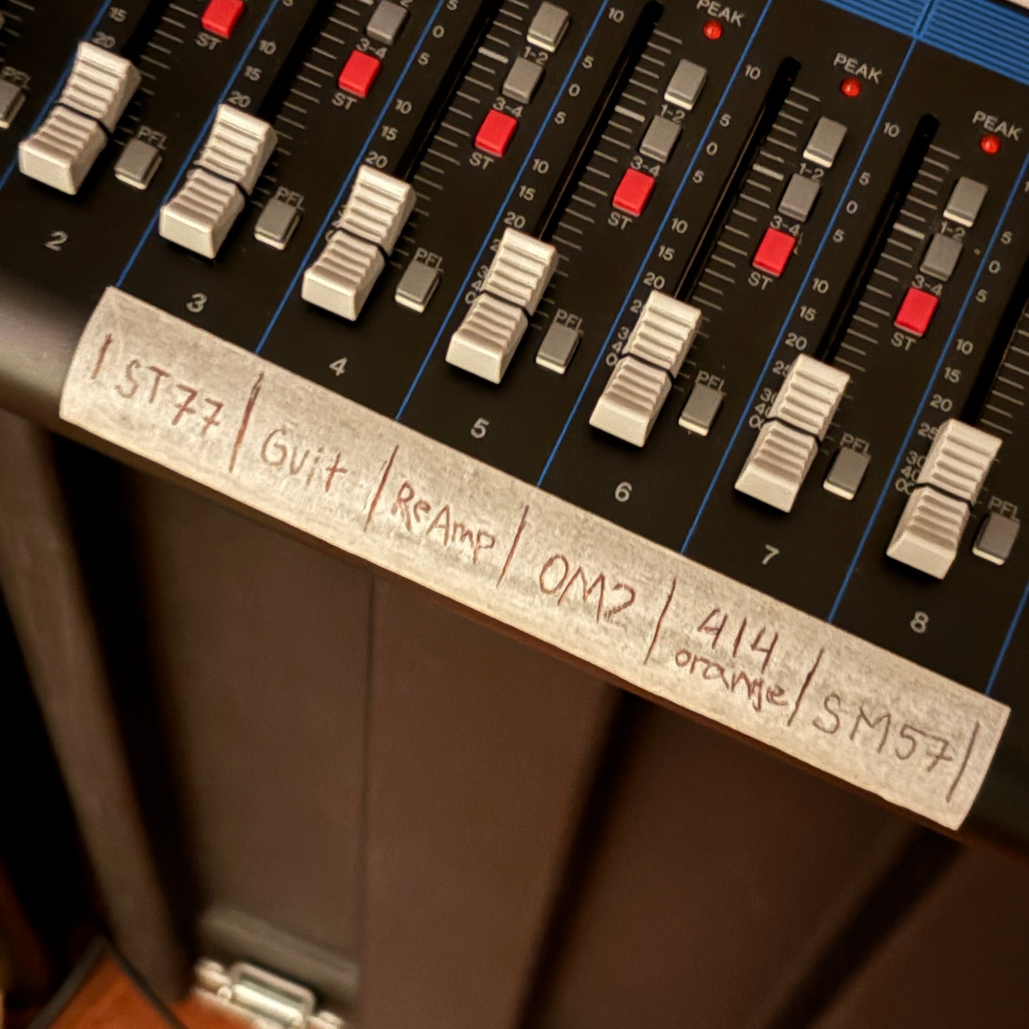 The faders on a mixing desk
